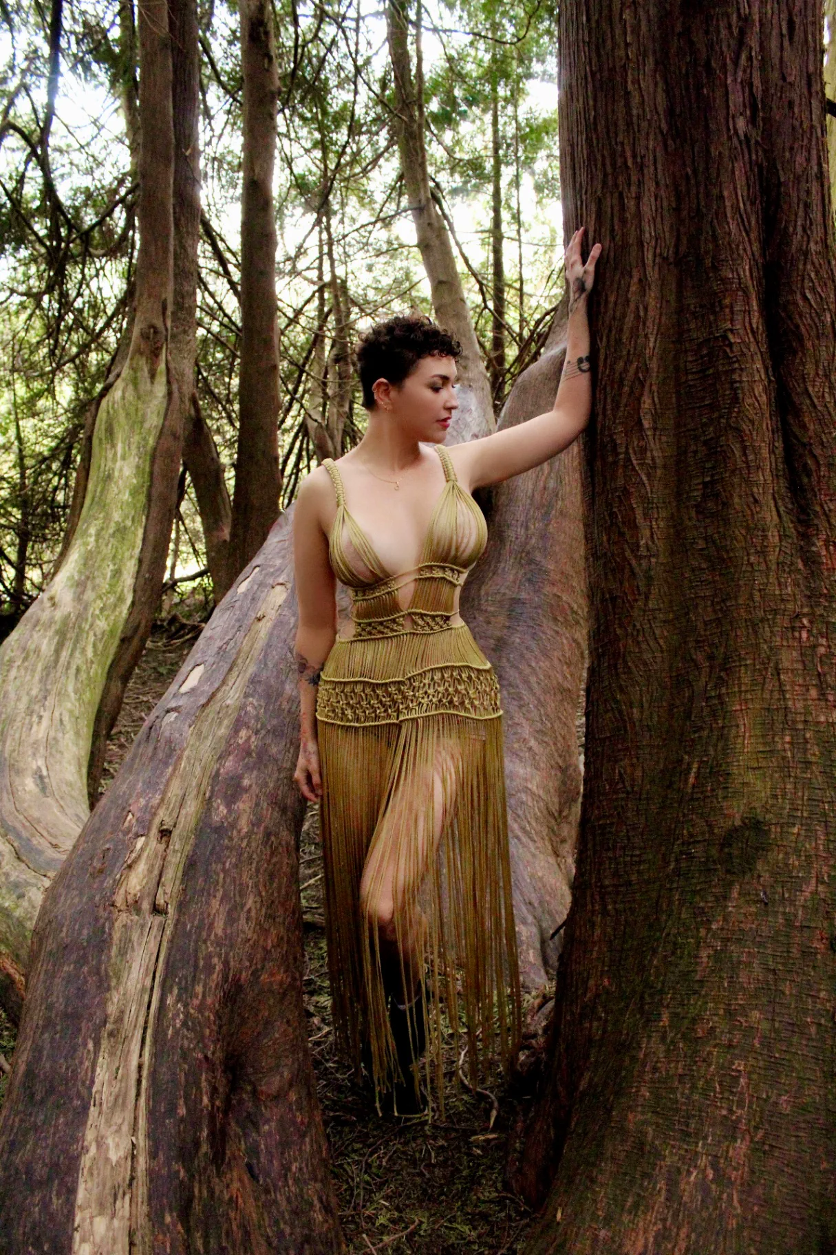 Mel standing in the forest, evoking the calm of a tantric bodywork session